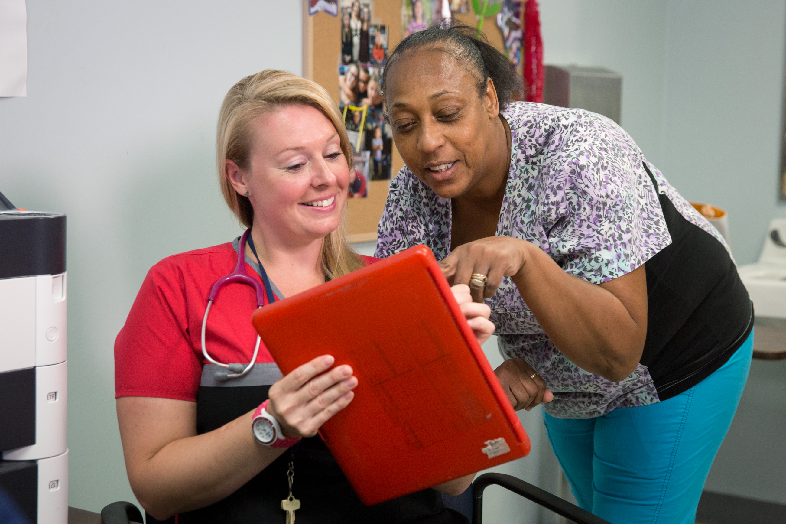 Nurse Sharon Piner reviews patient chart with co-worker