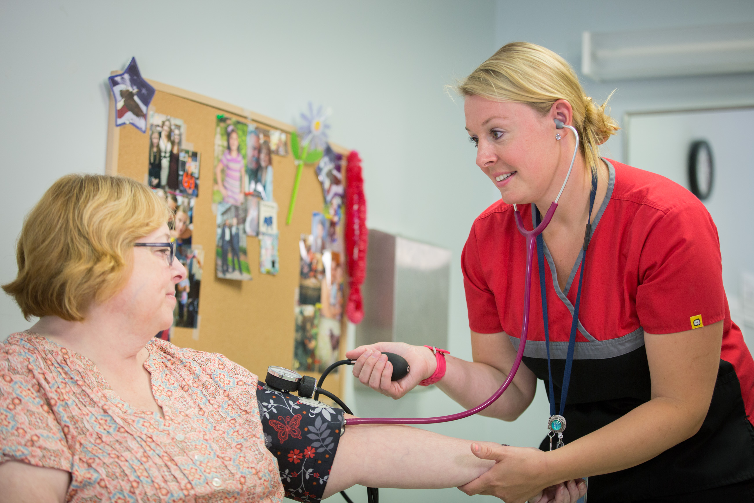 Nurse Sharon Piner checks the blood pressure of a patient